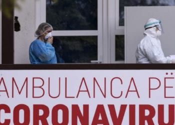 Members of the University Clinical Center of Kosovo in protective gear walk past a sign reading "Ambulance For Coronavirus" at the University Clinical Center of Kosovo in Pristina on March 14, 2020. - Kosovo reported its first coronavirus (COVID-19) case on March 13, 2020, in a 22-year-old Italian woman and a 77-year-old Kosovar man, both recently returned from Italy. (Photo by Armend NIMANI / AFP)