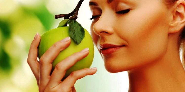 http://www.dreamstime.com/royalty-free-stock-images-woman-smelling-apple-image38289999