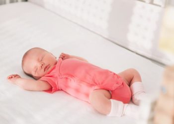Newborn baby girl sleep first days of life. Cute little newborn child sleeping peacefully