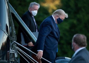 White House Chief of Staff Mark Meadows (L) watches as US President Donald Trump (C) walks off Marine One while arriving at Walter Reed Medical Center in Bethesda, Maryland on October 2, 2020. - President Donald Trump will spend the coming days in a military hospital just outside Washington to undergo treatment for the coronavirus, but will continue to work, the White House said Friday (Photo by Brendan Smialowski / AFP) (Photo by BRENDAN SMIALOWSKI/AFP via Getty Images)