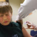 Reed Olson, 8, gets a flu shot at a Dekalb County health center in Decatur, Ga., Monday, Feb. 5, 2018. The U.S. government's latest flu report released on Friday, Feb. 2, 2018, showed flu season continued to intensify the previous week, with high volumes of flu-related patient traffic in 42 states, up from 39 the week before. (AP Photo/David Goldman)