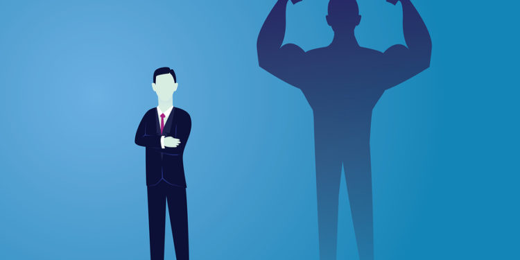 Vector illustration. Business power concept. Businessman standing in front of his own muscular shadow showing his inner strength. Self confidence. Future goal. Self development