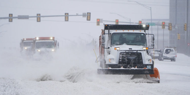 Snowplows works to clear the road during a winter storm Sunday, Feb. 14, 2021, in Oklahoma City. Snow and ice blanketed large swaths of the U.S. on Sunday, prompting canceled flights, making driving perilous and reaching into areas as far south as Texas’ Gulf Coast, where snow and sleet were expected overnight. (AP Photo/Sue Ogrocki)