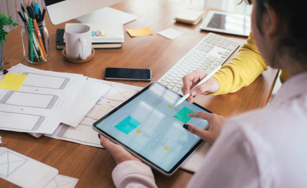 Web designer, UX UI designer designing mobile application user interface. Creative planning application development sketch layout wireframe design.
