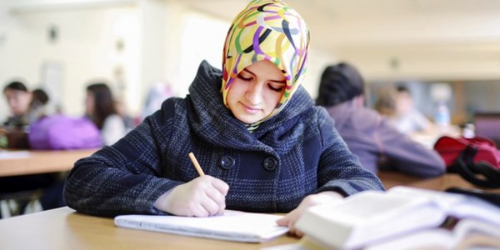 Muslim girl studying in library