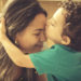 Little 2 years old boy, hugging and kissing his mother, with affectionate gesture.