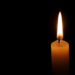 Dramatic burning candle flame on a black background with copy spaceгл