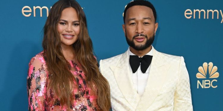 John Legend(R) and Chrissy Teigen arrive for the 74th Emmy Awards at the Microsoft Theater in Los Angeles, California, on September 12, 2022. (Photo by Robyn BECK / AFP)