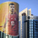 A giant FIFA World Cup advertisement on a skyscraper shows Switzerland's midfielder and captains Granit Xhaka on the eve of the FIFA World Cup Qatar 2022, in Doha West Bay district, Qatar, Saturday, November 19, 2022. The picture of the Swiss professional footballer who plays as a midfielder and vice captains in the Premier League club Arsenal is displays on the Minister of Environment and Climate Change tower which is approximately 109 meters high for 25 floors. The Swiss national soccer team will play in group G of the upcoming FIFA World Cup Qatar 2022. (KEYSTONE/Laurent Gillieron)
