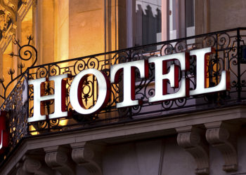 Illuminated hotel sign taken at dusk
