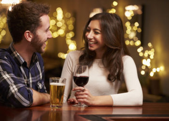 Couple Enjoying Evening Drinks In Bar