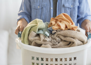 Man Holding Laundry Basket At Home
