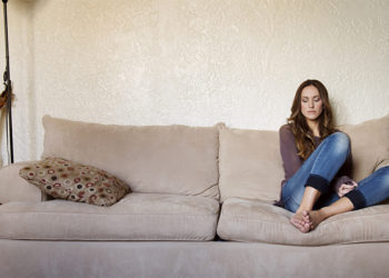 Woman Alone Resting On Couch